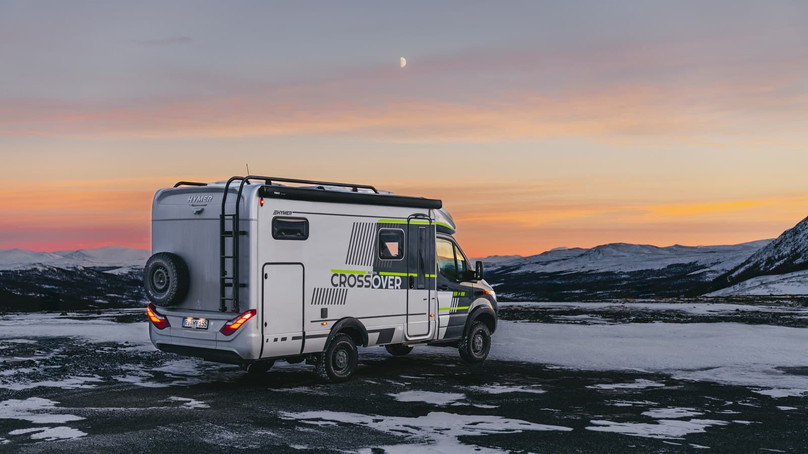 Hymer ML-T 570 Crossover sur base Mercedes stationné dans un paysage enneigé de Norvège au crépuscule, lune dans le ciel